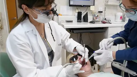 Dr. Rivero performing precise dental work on a patient